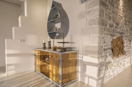 a mirror on top of a wooden cabinet in a room at Beachfront villa Komos with heated pool in Kalamaki