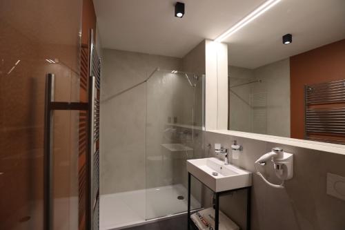 a bathroom with a shower and a sink and a shower at Ponton Rooms in Bratislava
