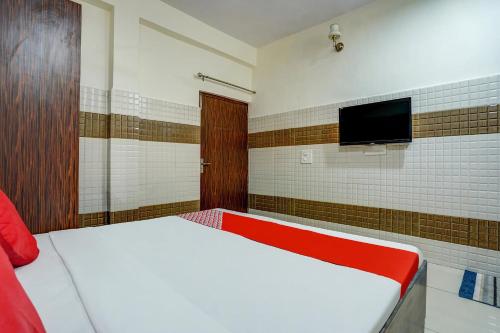 sypialnia z łóżkiem i telewizorem z płaskim ekranem w obiekcie Super OYO Hotel 7 Sky w mieście Ludhiana