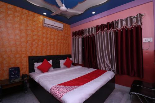 a bedroom with a bed with red pillows at OYO Hotel Jagannath International Near Kolkata Airport in Gauripur