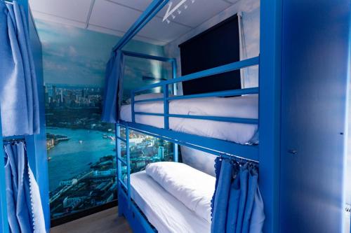 ロンドンにあるHostelle - women only hostel Londonの二段ベッド2組、窓が備わる客室です。