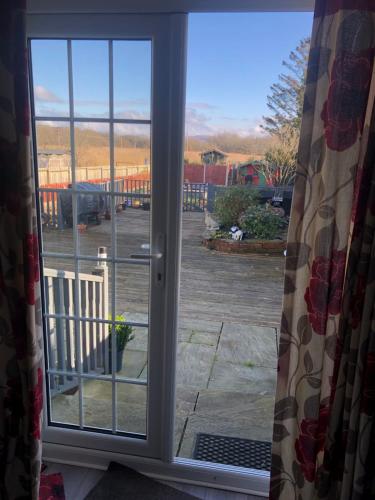 an open window with a view of a parking lot at Loughor Annnex, Llangennech , Wales 