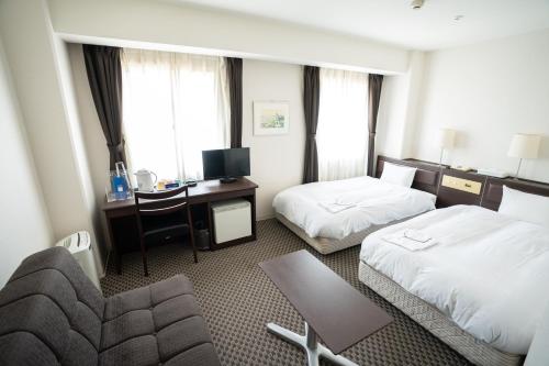 Postel nebo postele na pokoji v ubytování Hotel Casabella Inn Kobe