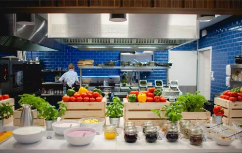 a kitchen with fruits and vegetables on a counter at Flatbook - City Center SPA Apartments Waterlane Island in Gdańsk