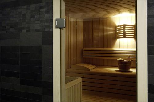 a small bathroom with a sauna with a sink at Hotel Meridiana in Malcesine