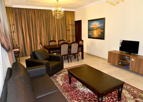 a living room with a couch and a table at Hanno Residence in Soûr