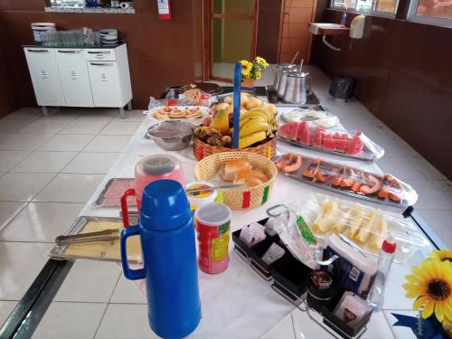 a table with a bunch of food on it at Portobello Hotel Orla in Santarém