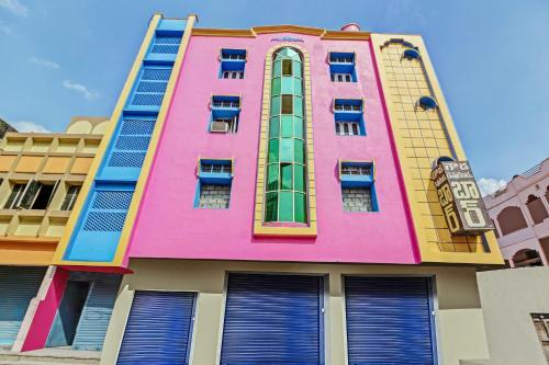 een felgekleurd gebouw met ramen en deuren bij OYO Suraj Residency in Warangal