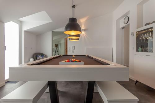 a pool table in a living room with a ping pong ball at Casa Alegria Barra Deluxe by Home Sweet Home Aveiro in Praia da Barra
