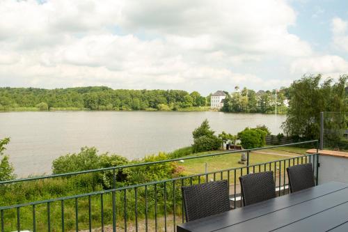 a view of a lake from the balcony of a house at Det Gamle Rådhus in Gråsten