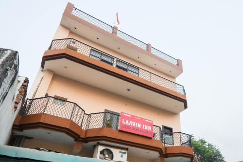 a building with a balcony and a sign on it at Hotel O Laavin Inn Near Gomti Riverfront Park in Lucknow