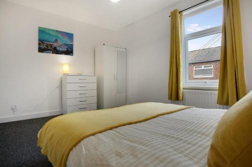 a bedroom with a bed and a dresser and a window at Freshly Renovated, Feels Like Home, Sleeps 3 in Chester-le-Street