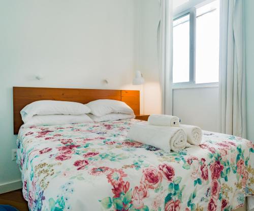 a bedroom with a bed with towels on it at Quarto e Sala Coraçao do Leblon in Rio de Janeiro