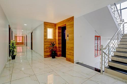 a hallway of a house with a staircase and a door at Super Capital O Krishnakripa Executive Stay in Muttam