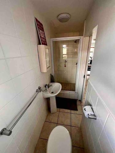 a bathroom with a toilet and a sink at Sea Gem with a stunning view in Boggomsbaai