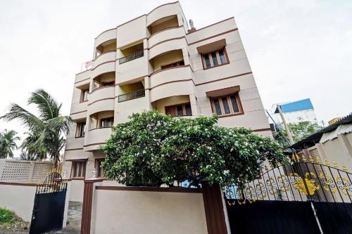 a building with a tree in front of it at Collection O Senthamizh Residency in Chennai