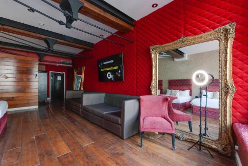 a red room with a mirror and a couch at Boutique 56 in Liverpool