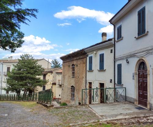 an old house with a gate in a yard at Nonna Domenica - Casa Vacanze @Gagliano Aterno in Gagliano Aterno