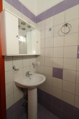 a bathroom with a sink and a mirror at Apartments Spartacus in Polychrono