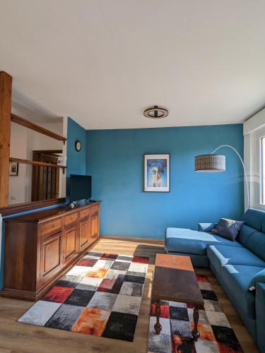 a living room with a couch and a tv at Maison Alice in Saint Vincent