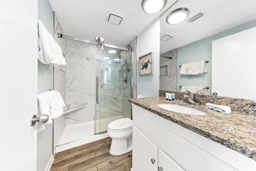 a bathroom with a shower and a toilet and a sink at Summer House 1105A in Orange Beach