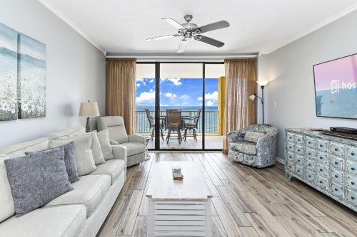 a living room with a couch and a ceiling fan at Summer House 1105A in Orange Beach