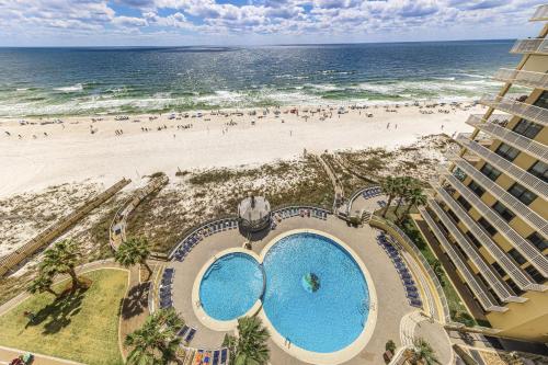 an overhead view of a beach with two pools and a building at Summer House 1105A in Orange Beach