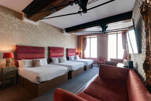 a hotel room with two beds and a couch at Boutique 56 in Liverpool