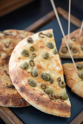 a group of three pizzas sitting on a tray at Clipper in Pesaro