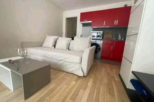 een woonkamer met een witte bank en rode kasten bij Studio 30m2 near Paris in Boulogne-Billancourt