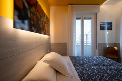a bedroom with a bed and a large window at Clipper in Pesaro
