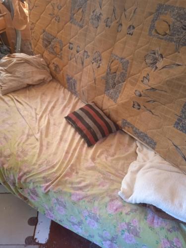 a bed with a quilt and pillows on it at Wanda aloja in Wanda