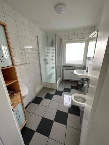 a bathroom with a toilet and a sink at Gästezimmer - Elbert in Hösbach