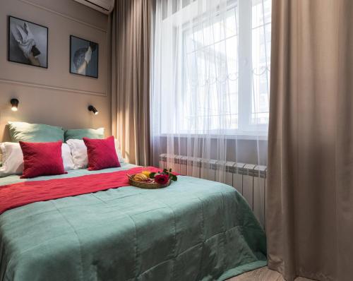 a bedroom with a bed with a bowl of fruit on it at Апартаменты Comfort Life 91 in Almaty