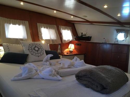 a bedroom with a large bed with towels on it at AsterixYacht-navigate to Greece,Turkey and so more in Marmaris