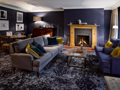 a living room with a couch and a fireplace at Landgoed De Holtweijde in Lattrop