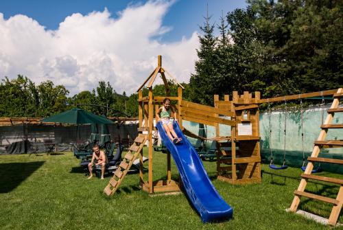 a girl on a slide in a playground at Casa Moroeni in Moroeni