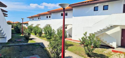 a red street light next to a white building at FKK Ada Bojana in Ulcinj