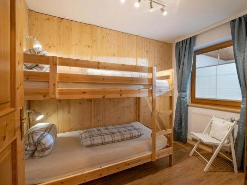 a bunk bed in a room with a ladder at Ferienwohnung Stock in Kirchdorf in Tirol