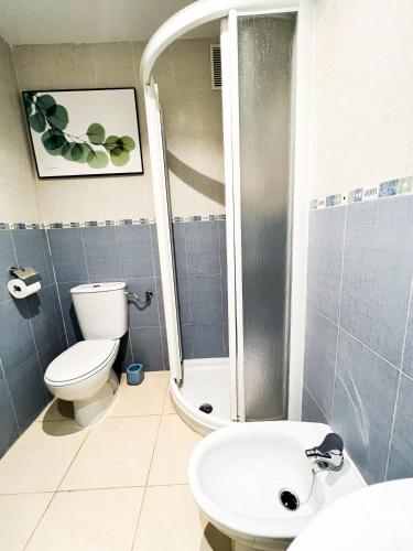a bathroom with a shower and a toilet and a sink at Renovated apartment on the first line in Oropesa del Mar