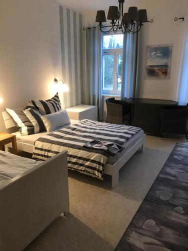 a living room with two beds and a couch at Pension Eichler in Löbau