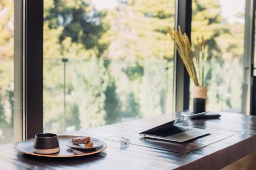 a table with a hat and a plate of food at Life Gallery Athens in Athens