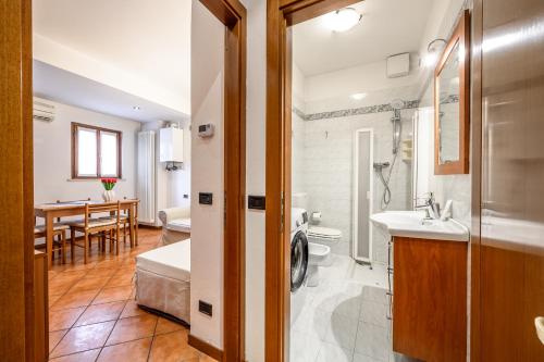 a bathroom with a shower and a sink and a toilet at Intimo appartamento sui tetti di Verona in Verona