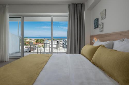 a bedroom with a bed with a view of the ocean at Hotel Kriopigi in Kriopigi