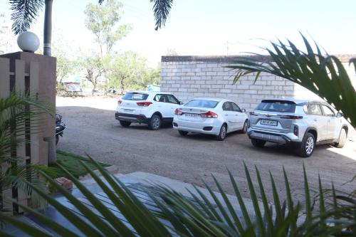 a group of cars parked in a parking lot at Hotel Grand Ecotel, Aurangabad in Aurangabad
