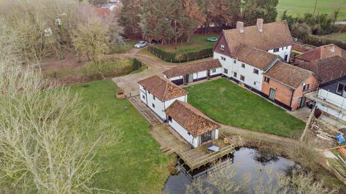 an aerial view of a large house with a yard at Amazing Spa Country House with Indoor Pool, Sauna and Steam Room in Tibenham