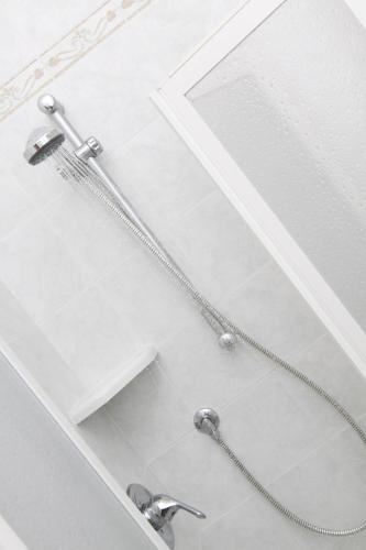 a shower with two faucets in a bathroom at Hotel Orsa Maggiore in Milano Marittima