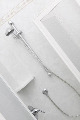 um chuveiro com duas torneiras numa casa de banho em Hotel Orsa Maggiore em Milano Marittima