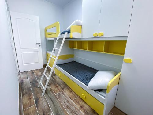 a bunk bed with a ladder in a room at Viterbo Holiday House in Viterbo