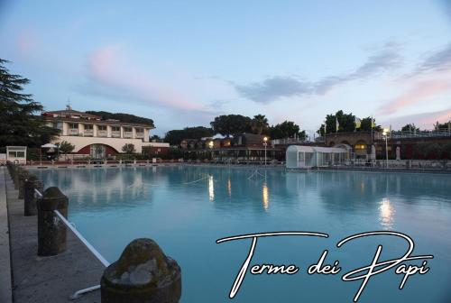 a large pool of water with a building in the background at Viterbo Holiday House in Viterbo